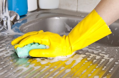 Upholstery cleaning equipment preparing a fabric sofa for deep cleaning